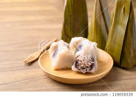 Thai dessert, Steamed rice flour stuffed with sweet coconut wrapped in banana leaf Thai dessert, Steamed rice flour stuffed with sweet coconut wrapped in banana leaf 119059339