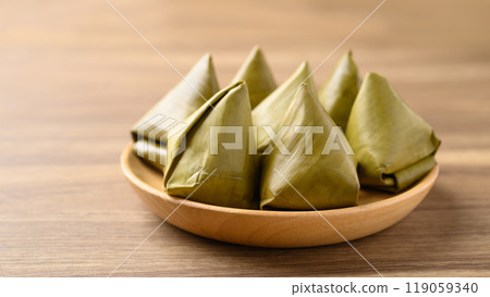 Thai dessert (Khanom Tian), Sweet dough pyramid stuffed with mung bean wrapped by banana leaf Thai dessert (Khanom Tian), Sweet dough pyramid stuffed with mung bean wrapped by banana leaf 119059340