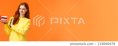 No thanks, dont want. Cute redhead girl trying resist temptation take bite delicious sweets, holding tasty cake and showing stop, refusal or rejection with grimacing face, express aversion, dislike No thanks, dont want. Cute redhead girl trying resist temptation take bite delicious sweets, holding tasty cake and showing stop, refusal or rejection with grimacing face, express aversion, dislike 119060476