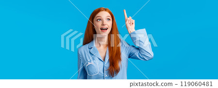 Girl having excellent idea. Attractive redhead female in cute pyjamas raising index finger up air and telling her idea, open mouth look excited, made up perfect plan, solution, wear nightwear Girl having excellent idea. Attractive redhead female in cute pyjamas raising index finger up air and telling her idea, open mouth look excited, made up perfect plan, solution, wear nightwear 119060481