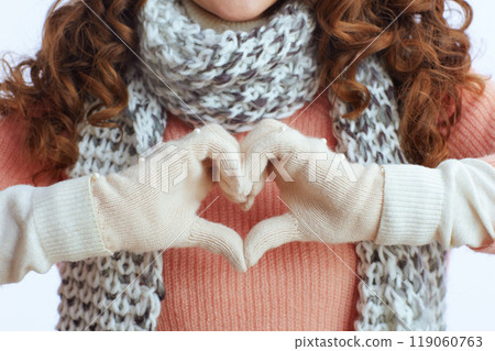 Modern 40 years old woman showing heart hands on white Modern 40 years old woman showing heart hands on white 119060763