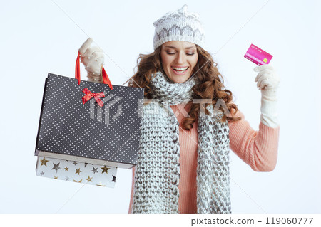 happy stylish woman in sweater, mittens, hat and scarf on 119060777