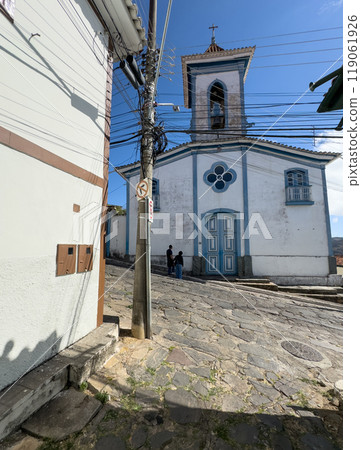 Quaint Church Facade with Cobblestone Street in Old Town 119061926