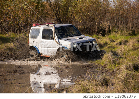Small japanese suv crossing water obstacle Small japanese suv crossing water obstacle 119062379
