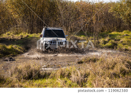 Small japanese suv overcomes water obstacle 119062380