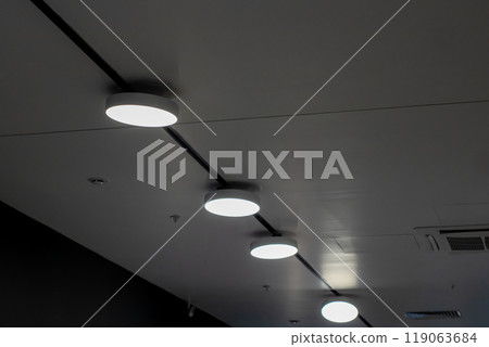 A ceiling adorned with numerous lights illuminating the space above it A ceiling adorned with numerous lights illuminating the space above it 119063684