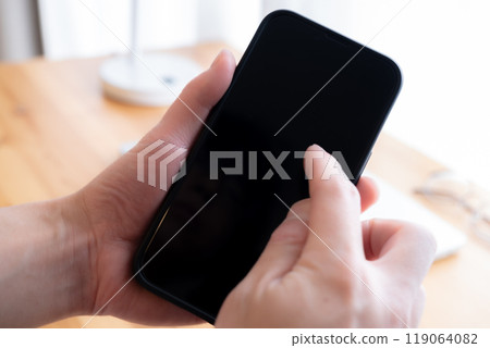 Operating a smartphone Operating a smartphone 119064082