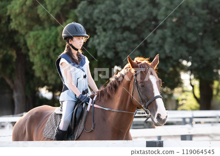 Girls enjoying horseback riding Girls enjoying horseback riding 119064545