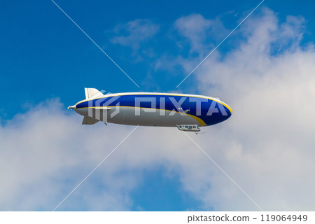An airship against a background of blue sky and white clouds 119064949