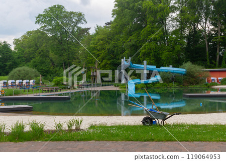 cleaning swimming pond in park  119064953