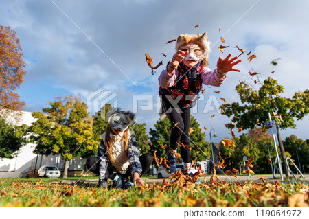 Cute young little kid girl wear cat furry mask enjoy have fun playing outdoors in forest street park. Children therian wild animal character trendy fan culture. Teenager social expression hobby 119064972