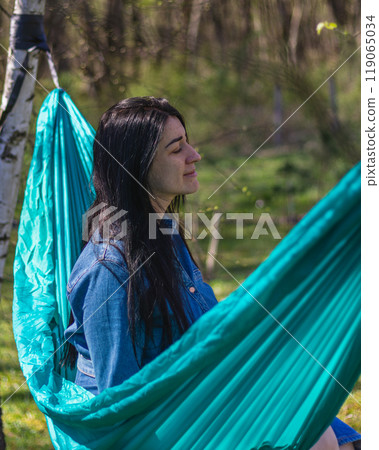 A woman relaxes in a hammock in the garden Lviv Ukraine 07.04.2024 A woman relaxes in a hammock in the garden Lviv Ukraine 07.04.2024 119065034