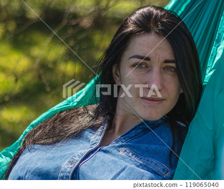 A woman relaxes in a hammock in the garden Lviv Ukraine 07.04.2024 A woman relaxes in a hammock in the garden Lviv Ukraine 07.04.2024 119065040
