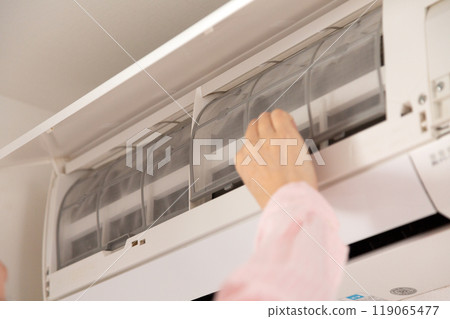 Woman's hand holding a used air conditioner filter Woman's hand holding a used air conditioner filter 119065477