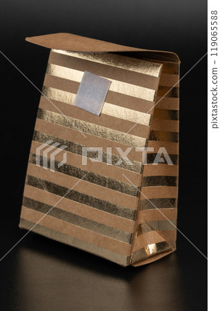 Elegant gold and silver striped gift bag on a dark background 119065588