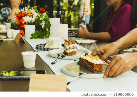 Waitresss serving slice of cake on the table in cafe. 119066006