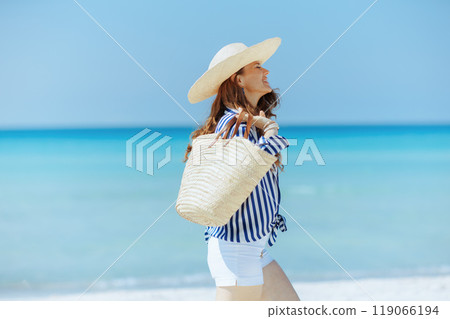 smiling modern woman on ocean coast 119066194