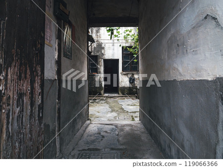 Narrow passageway leading to a secluded courtyard in an old urban neighborhood 119066366