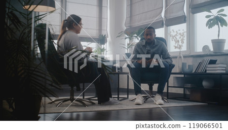 Psychological office: Depressed African American adult man talking to therapist 119066501