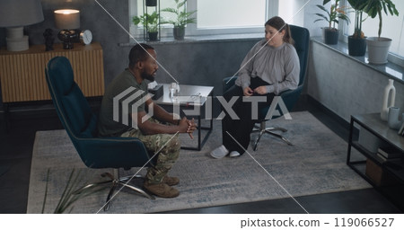 African American military man with PTSD on counseling session with psychologist African American military man with PTSD on counseling session with psychologist 119066527