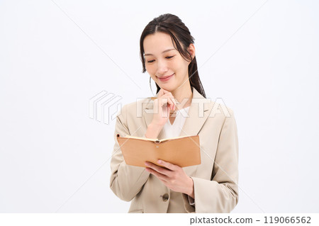 Writing in a notebook Business woman Writing in a notebook Business woman 119066562