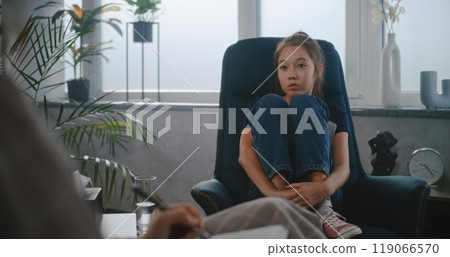 Asian school-aged girl talks to child therapist, shares feelings Asian school-aged girl talks to child therapist, shares feelings 119066570