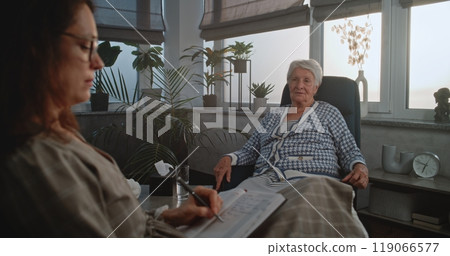 Workplace of psychologist: Female specialist listens to patient's story Workplace of psychologist: Female specialist listens to patient's story 119066577