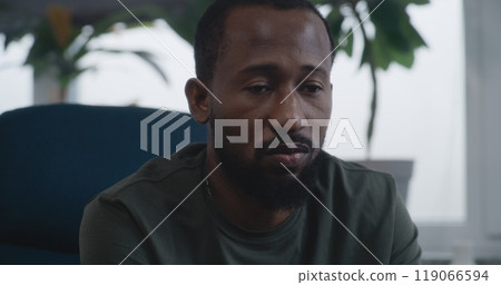 Close up of African American military man with PTSD sharing traumatic experience on therapy session Close up of African American military man with PTSD sharing traumatic experience on therapy session 119066594