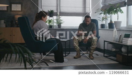 African American soldier shares traumatic experience during therapy session 119066631
