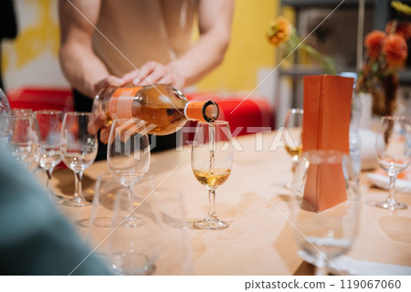 Pouring premium whiskey into glasses at a tasting event, Luxury, celebration, and social gatherings 119067060