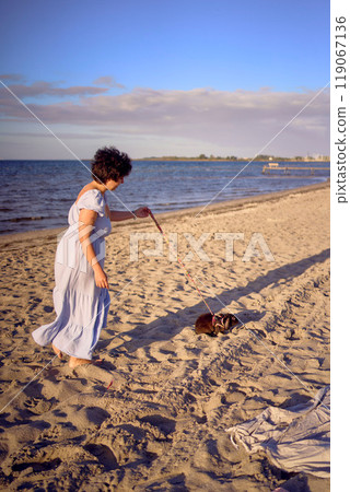 young plus size woman walking and playing with her pet rabbit by the sea in Copenhagen young plus size woman walking and playing with her pet rabbit by the sea in Copenhagen 119067136