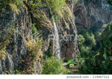 mountain waterfall among rocks and plants mountain waterfall among rocks and plants 119067322