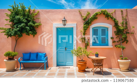 Dayllght courtyard with furniture and plants and peach color facade. Beautiful south style building Dayllght courtyard with furniture and plants and peach color facade. Beautiful south style building 119067580