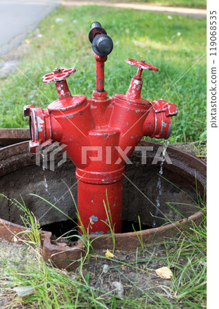 Red fire hydrant for extinguishing a fire in the city 119068535