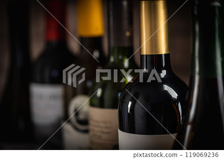 Selection of Wine Bottles with Grapes and Glass in Background Selection of Wine Bottles with Grapes and Glass in Background 119069236