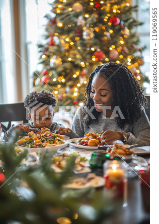 A joyful Christmas dinner with a mother and son enjoying a festive meal at home surrounded by holiday decorations 119069565