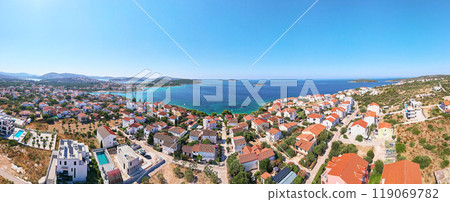 Aerial view of coastal town with colorful buildings near sea coastline. Touristic city for summer vacation with red roof houses and Islands in Adriatic sea. Panoramic view of Rogoznica town in Croatia Aerial view of coastal town with colorful buildings near sea coastline. Touristic city for summer vacation with red roof houses and Islands in Adriatic sea. Panoramic view of Rogoznica town in Croatia 119069782