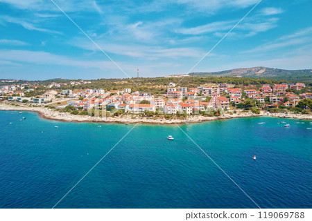 Aerial view of Adriatic sea coastline with coastal village and boats along shoreline. Panorama of tourist town Rogoznica in Croatia on Adriatic Sea. Summer travel concept 119069788