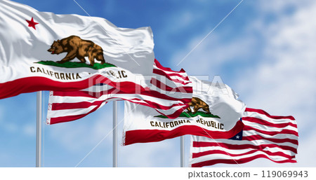 California and the US flags waving in the wind on a clear day 119069943