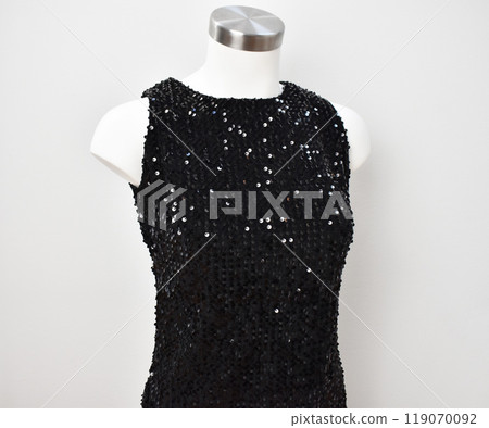 Black sequins dress on white background, fancy evening clothes 119070092