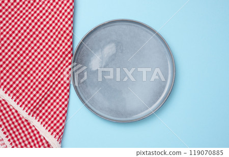 Round ceramic empty blue plate and red kitchen towel Round ceramic empty blue plate and red kitchen towel 119070885