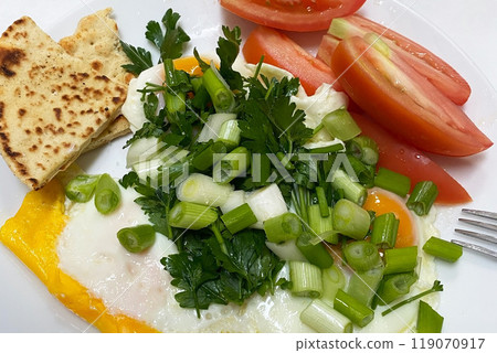 Fresh healthy food with greens on plates close view 119070917