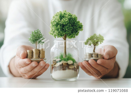 Three jars with small trees growing from stacks of coins held by hands 119071088