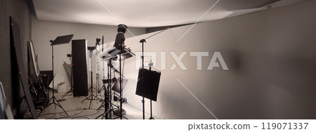 Photo or Video production studio with professional equipment preparation before shooting. Studio LED continuous lights arranging behind diffuser plates for softer light to the product and background. Photo or Video production studio with professional equipment preparation before shooting. Studio LED continuous lights arranging behind diffuser plates for softer light to the product and background. 119071337