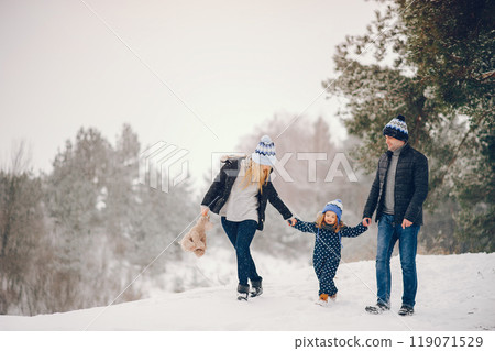 Family have fun in a winter park. Stylish mother in a blue jacket. Little girl in a winter clothes. Father with cute daughter Family have fun in a winter park. Stylish mother in a blue jacket. Little girl in a winter clothes. Father with cute daughter 119071529
