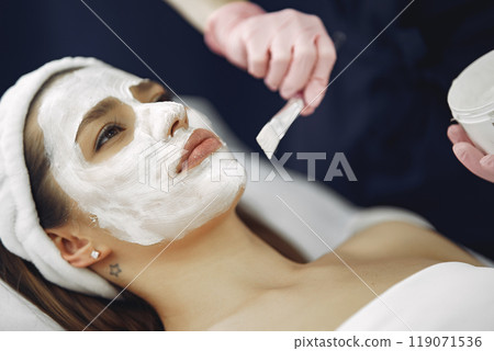 Cosmetologist treats client's skin. Woman with cosmetologist. Lady in a beauty studio. 119071536