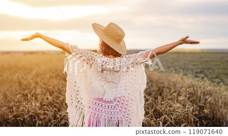 Boho Rustic Styled Woman With Open Up Arms In Wheat Field To Sun. Hands Up. Free Girl, Amazing Summer Adventure Boho Rustic Styled Woman With Open Up Arms In Wheat Field To Sun. Hands Up. Free Girl, Amazing Summer Adventure 119071640