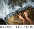 bare feet in a cold stream with rapids 119071830