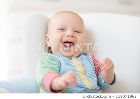 Little baby on white chair Little baby on white chair 119071962