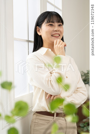 一個女人站在窗邊擺姿勢 一個女人站在窗邊擺姿勢 119072348